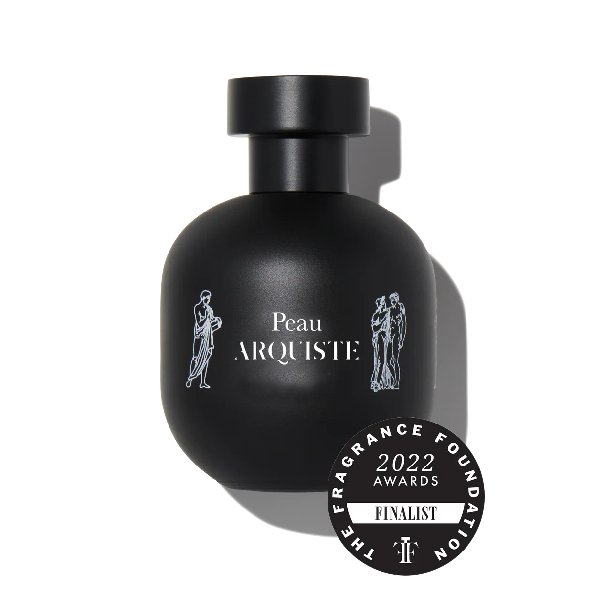 Celeste in a warm cream silk slip beside a slim Arquiste Peau flacon filled with warm amber juice with a black cap on a sand-toned minimalist table